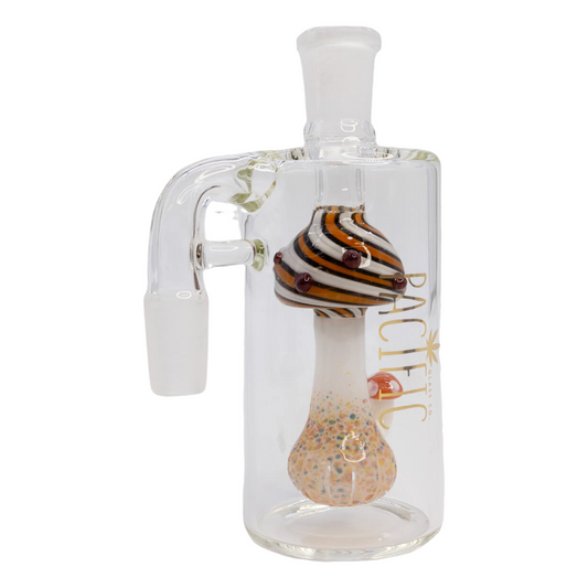 A clear glass ash catcher with a mushroom-shaped percolator with speckled accents and a 3D polka dot mushroom for aesthetic purposes. It has a 90-degree angle and is designed to hold water for filtration.